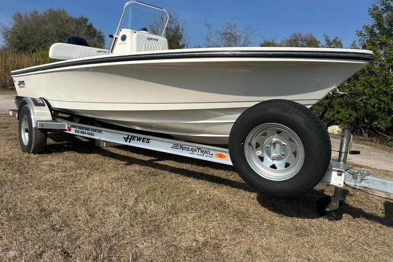 Slide: The Image of 2026 Hewes Redfisher 16 boat on trailer, parked on grass under clear sky. - 3