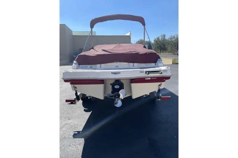 Slide: The Image of 2013 Chaparral 226 SSi boat with maroon cover, rear view in sunlight. - 3