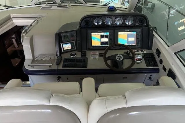 Slide: The Image of Cockpit of 2008 Sea Ray 48 Sundancer with dual screens and leather seating. - 13