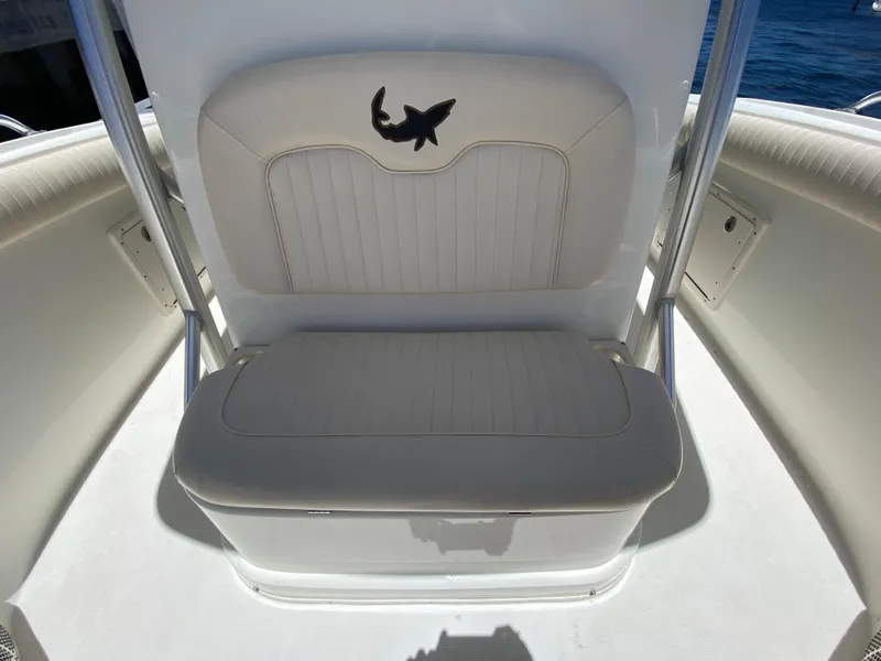 Slide: The Image of White seating on 2014 Mako 284 CC boat with shark logo, ocean background. - 11