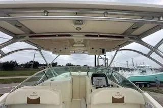Slide: The Image of 2010 World Cat 290 DC boat interior with seating and helm, showcasing spacious design. - 12