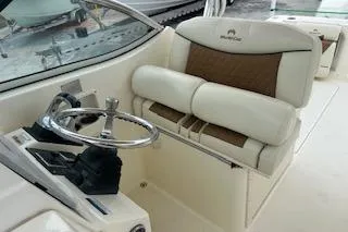Slide: The Image of 2010 World Cat 290 DC boat interior with steering wheel and cushioned seating. - 22