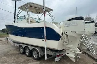 Slide: The Image of 2010 World Cat 290 DC boat on trailer with dual Suzuki outboard engines. - 5