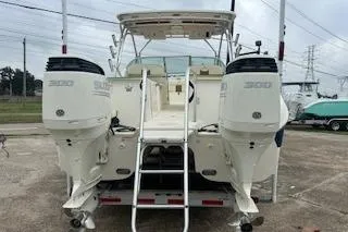 Slide: The Image of 2010 World Cat 290 DC boat with dual engines, viewed from the rear. - 7