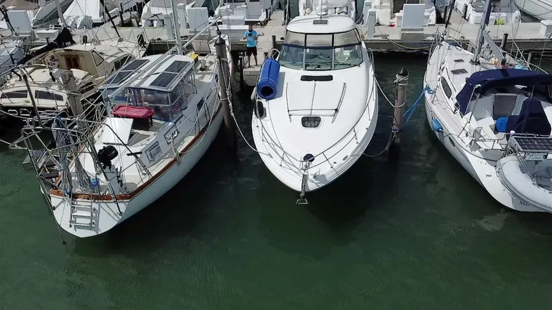 Slide: The Image of 2007 Sea Ray 40 Sundancer docked between two boats at a marina. - 1