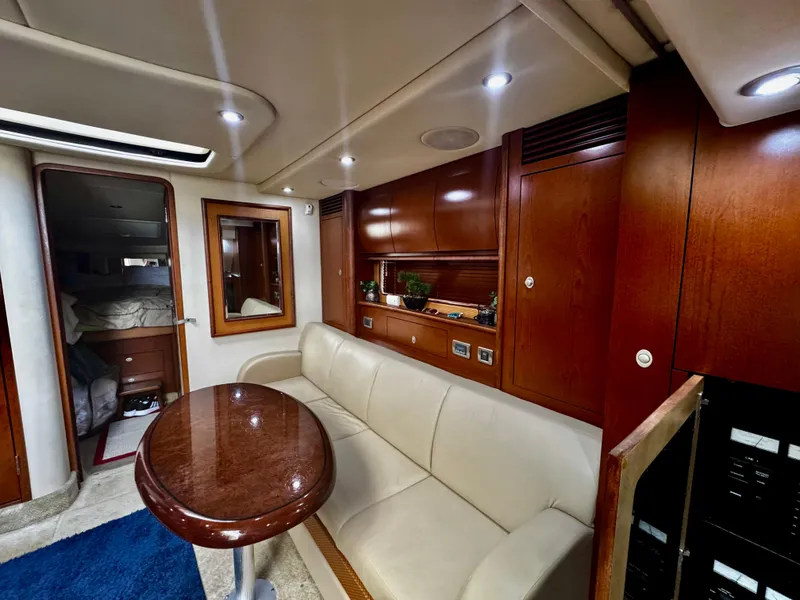 Slide: The Image of 2007 Sea Ray 40 Sundancer interior with leather seating, wooden cabinetry, and a polished table. - 10