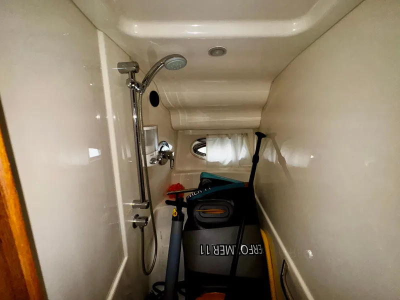Slide: The Image of Shower area in 2007 Sea Ray 40 Sundancer, used for storage with paddleboard equipment. - 13