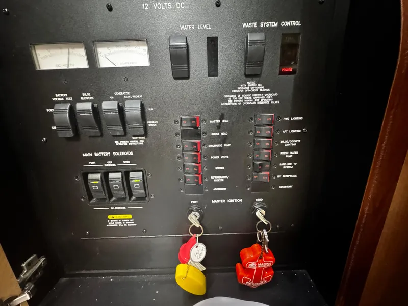 Slide: The Image of Control panel of a 2007 Sea Ray 40 Sundancer boat with switches and gauges. - 17
