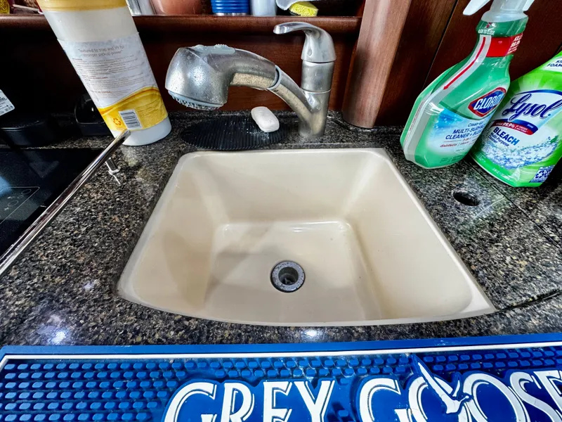 Slide: The Image of Kitchen sink area on a 2007 Sea Ray 40 Sundancer yacht with cleaning supplies. - 20