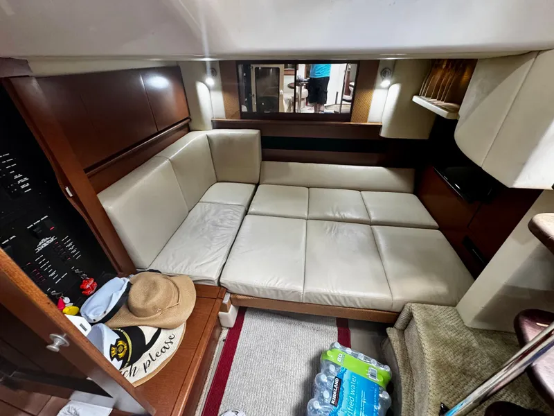 Slide: The Image of Interior of 2007 Sea Ray 40 Sundancer with beige seating and wooden accents. - 33