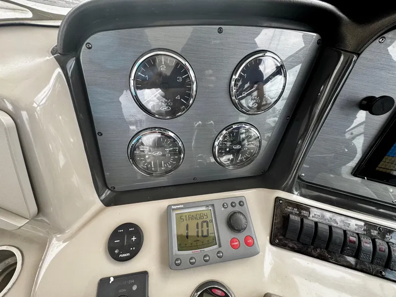 Slide: The Image of Dashboard of a 2007 Sea Ray 40 Sundancer boat with gauges and controls. - 39