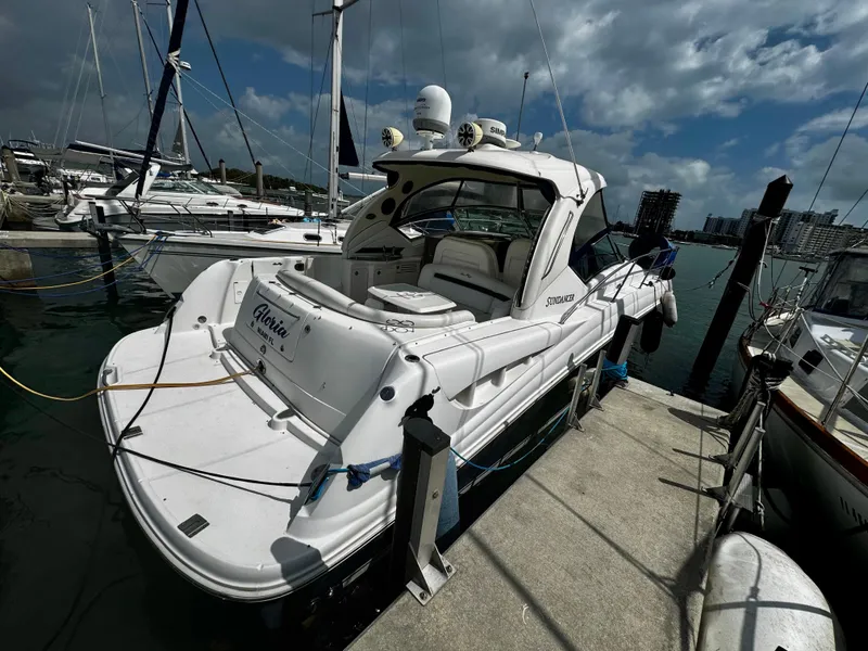Slide: The Image of 2007 Sea Ray 40 Sundancer yacht docked at marina under cloudy sky. - 4