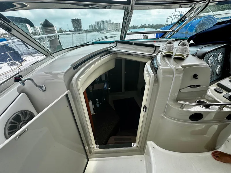 Slide: The Image of 2007 Sea Ray 40 Sundancer cockpit with open cabin door, overlooking marina and cityscape. - 41