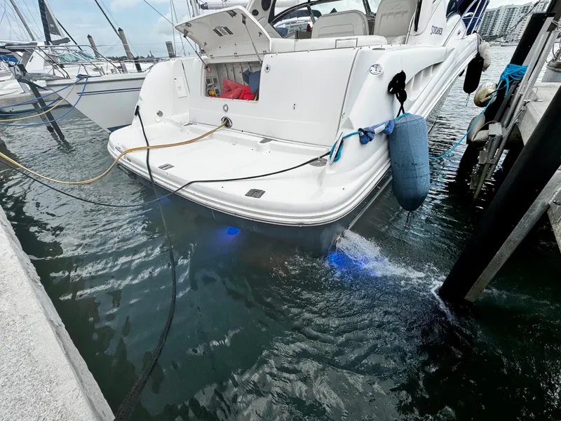 Slide: The Image of 2007 Sea Ray 40 Sundancer docked, rear view with blue underwater lights. - 48