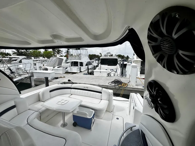 Slide: The Image of 2007 Sea Ray 40 Sundancer yacht interior with marina view, featuring plush seating and speakers. - 7