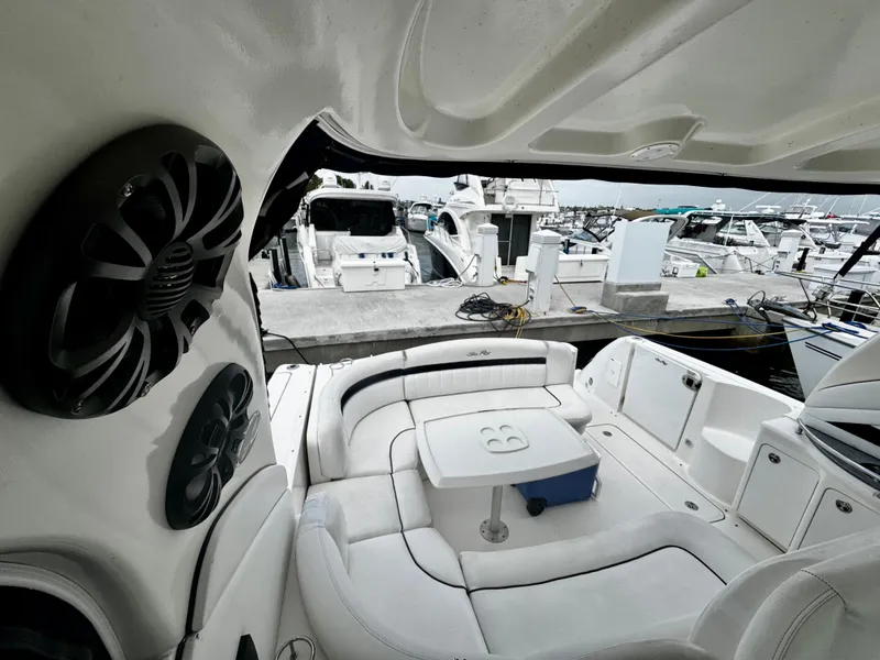 Slide: The Image of Interior view of 2007 Sea Ray 40 Sundancer yacht with white seating and marina backdrop. - 8