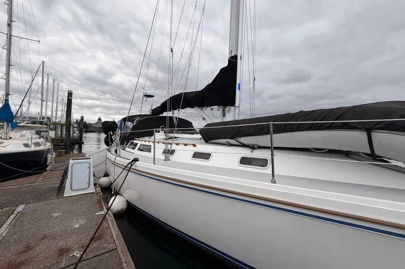 Slide: The Image of 1989 Catalina 42 sailboat docked at marina under cloudy sky. - 1