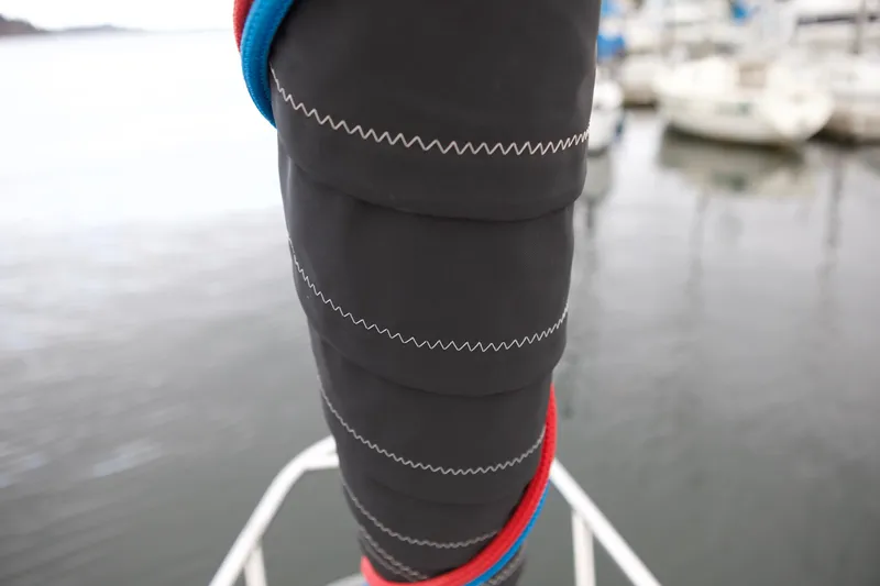 Slide: The Image of Close-up of Catalina 42 sailboat rigging, showcasing detailed stitching and colorful ropes. - 10