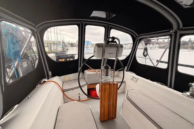 Slide: The Image of Interior view of a 1989 Catalina 42 sailboat cockpit with steering wheel and seating. - 17