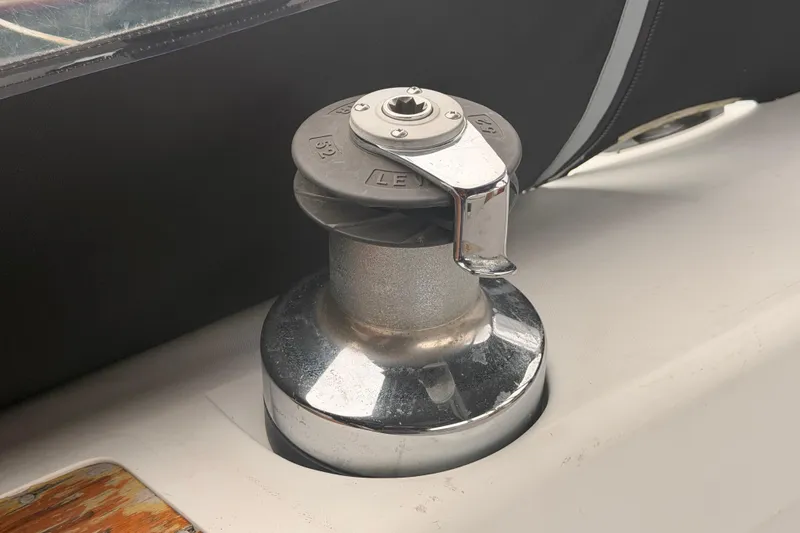 Slide: The Image of Winch on 1989 Catalina 42 sailboat deck, featuring chrome finish and handle. - 18