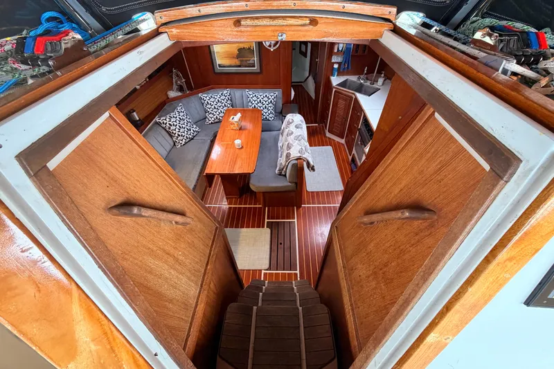 Slide: The Image of Interior of 1989 Catalina 42 sailboat with cozy seating and wooden finishes. - 24