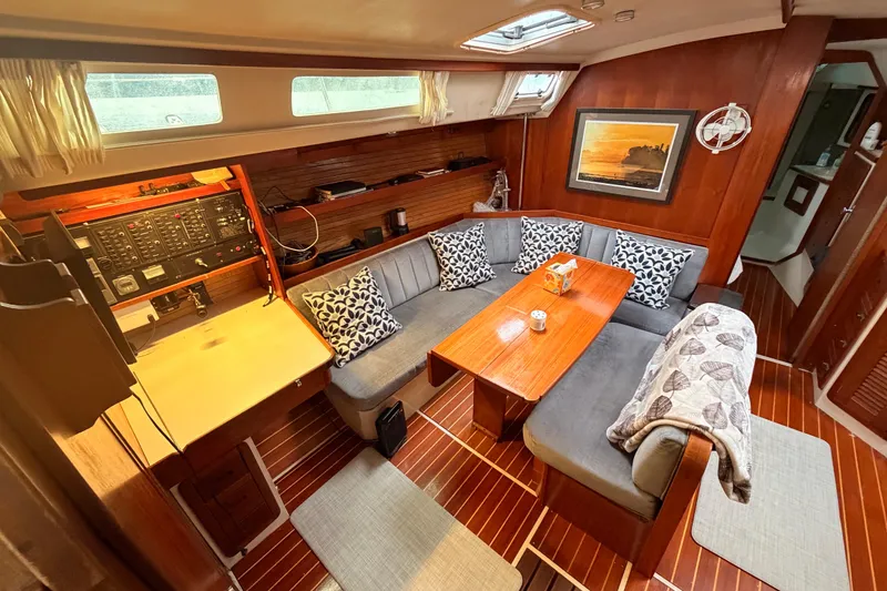 Slide: The Image of Interior of 1989 Catalina 42 sailboat with cozy seating and wooden table. - 26