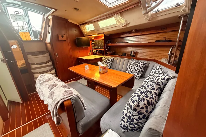 Slide: The Image of Interior of 1989 Catalina 42 sailboat with cozy seating and wooden finishes. - 31