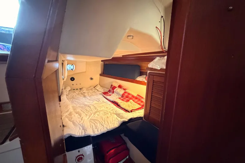 Slide: The Image of Cozy cabin interior of 1989 Catalina 42 sailboat with bed and wooden accents. - 35