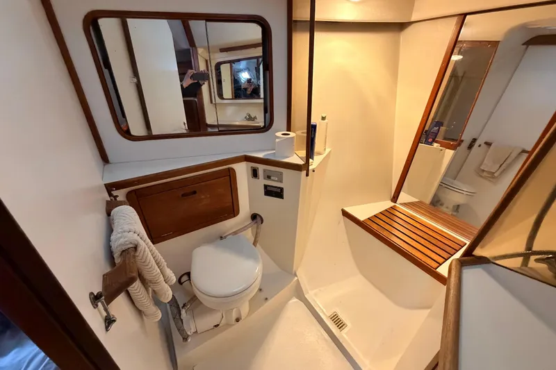 Slide: The Image of Bathroom interior of 1989 Catalina 42 sailboat with wooden accents and mirror. - 38