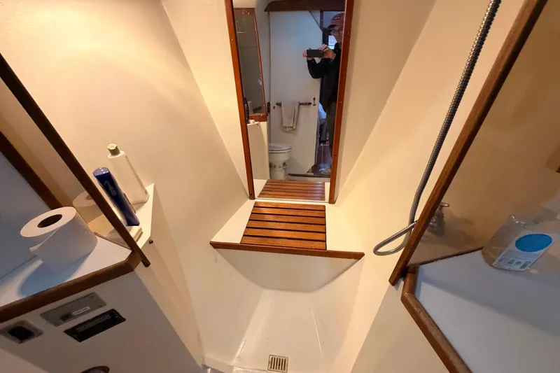 Slide: The Image of Bathroom interior of 1989 Catalina 42 sailboat with shower and wooden accents. - 39