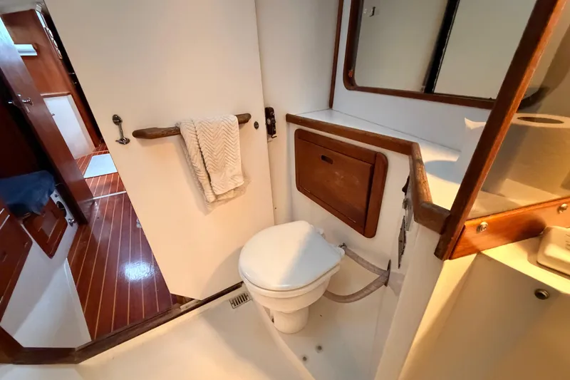Slide: The Image of 1989 Catalina 42 yacht bathroom with wooden accents and white fixtures. - 40
