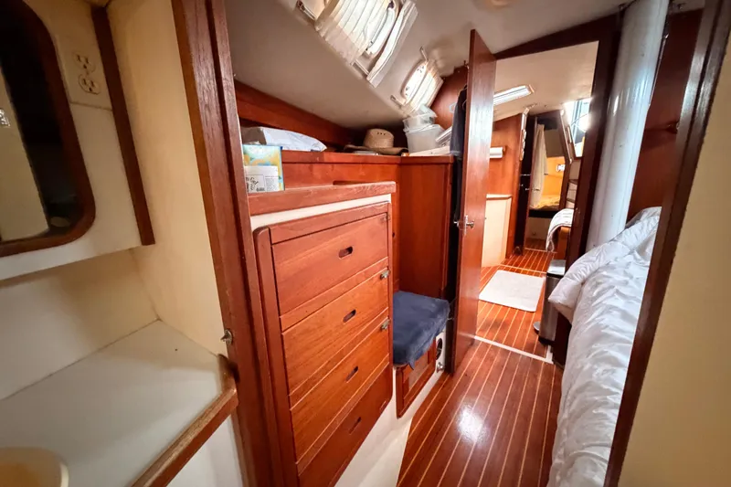 Slide: The Image of Interior of 1989 Catalina 42 sailboat with wooden cabinetry and cozy sleeping quarters. - 41