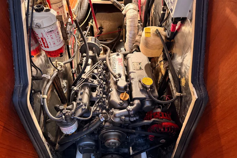 Slide: The Image of Engine compartment of a 1989 Catalina 42 sailboat, featuring a Yanmar diesel engine. - 43