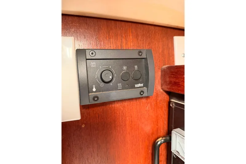 Slide: The Image of Control panel on 1989 Catalina 42 yacht, featuring temperature and fan settings. - 44