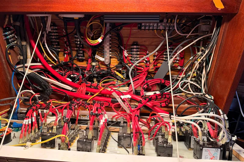 Slide: The Image of Electrical wiring panel inside a 1989 Catalina 42 sailboat, showcasing complex cable arrangement. - 46