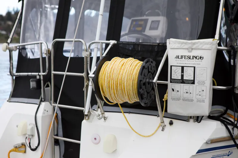 Slide: The Image of 1989 Catalina 42 sailboat with Lifesling rescue system and coiled rope on deck. - 5