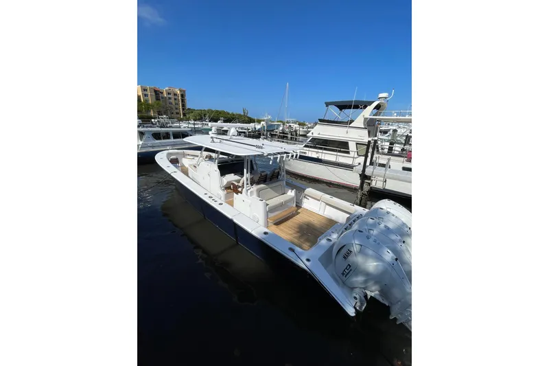 Slide: The Image of 2025 Jupiter 43 boat docked at marina under clear blue sky. - 22