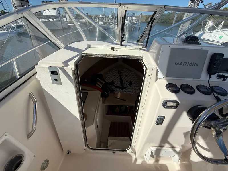 Slide: The Image of 2006 Cobia 250 Walk-Around boat interior with Garmin navigation system. - 13