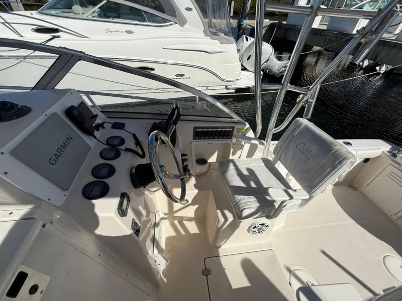 Slide: The Image of 2006 Cobia 250 Walk-Around boat cockpit with Garmin navigation system and seating. - 9
