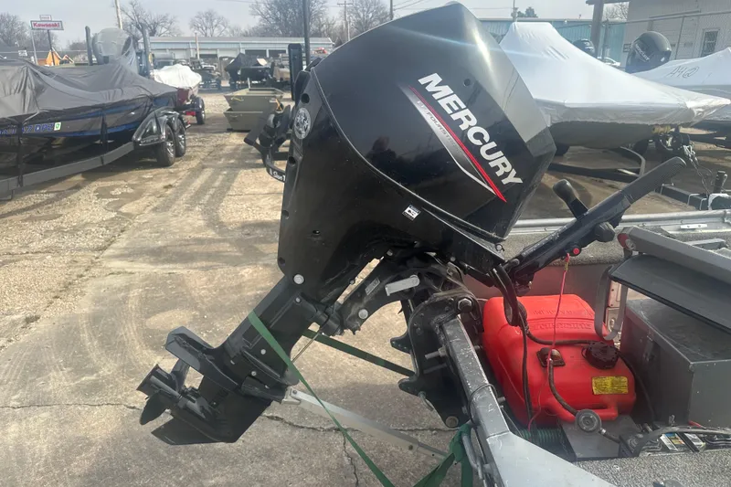 Slide: The Image of Mercury outboard motor on 1991 Grumman Rogue 150 T boat, parked in a marina. - 9