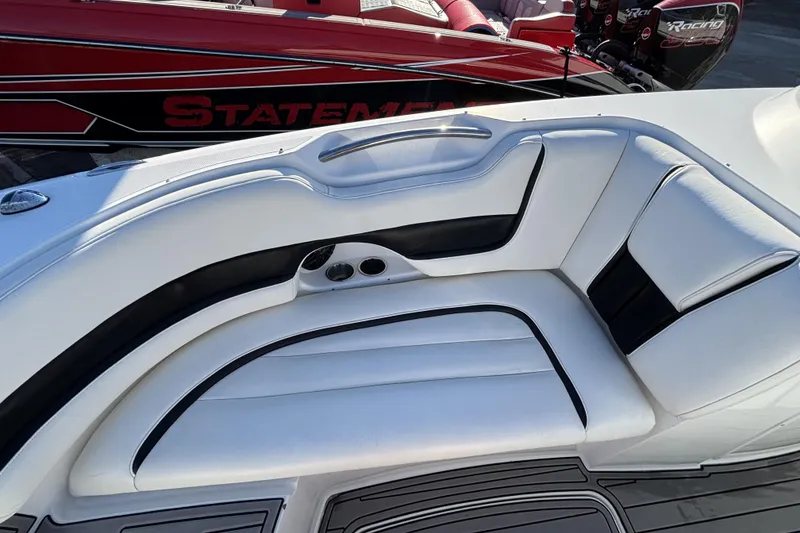 Slide: The Image of 2014 Hurricane SunDeck 2690 OB boat with white and black seating, cup holders, and sleek design. - 11