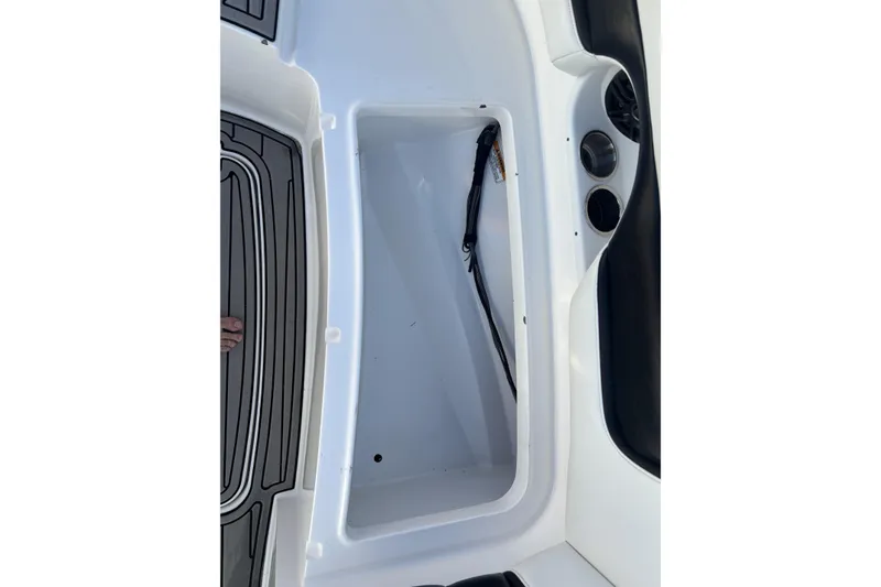 Slide: The Image of 2014 Hurricane SunDeck 2690 OB storage compartment with black and white interior design. - 13