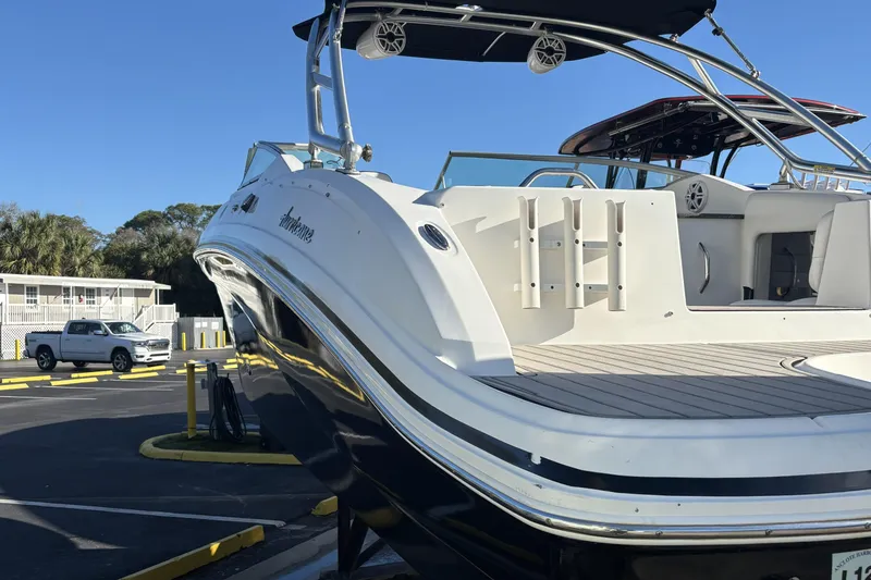 Slide: The Image of 2014 Hurricane SunDeck 2690 OB boat in parking lot, rear view. - 3