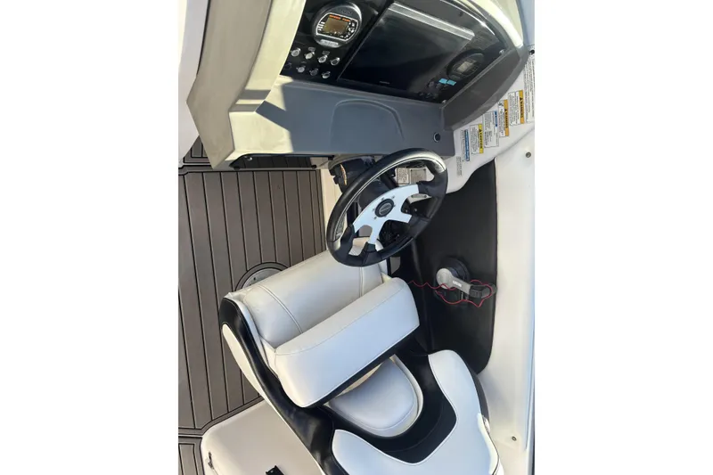 Slide: The Image of 2014 Hurricane SunDeck 2690 OB boat cockpit with steering wheel and control panel. - 8