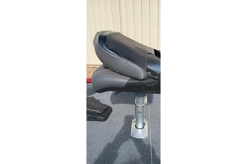 Slide: The Image of 2025 Tracker Pro Team 175 boat seat, black and gray, on a metal pedestal. - 11