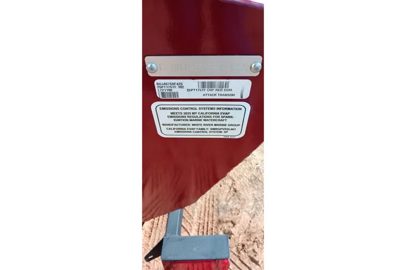 Slide: The Image of 2025 Tracker Pro Team 175 emissions control information label on red surface. - 12