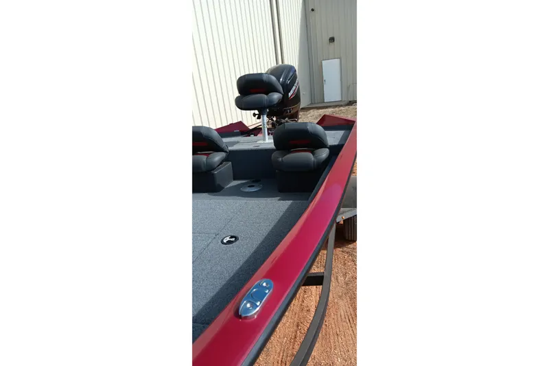 Slide: The Image of 2025 Tracker Pro Team 175 boat with red exterior and black seats. - 3