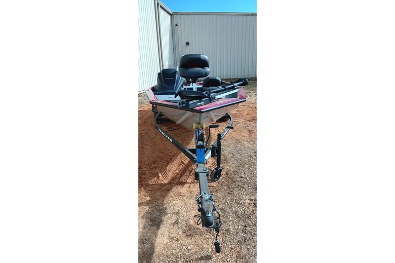 Slide: The Image of 2025 Tracker Pro Team 175 boat on trailer, parked outdoors near a building. - 4