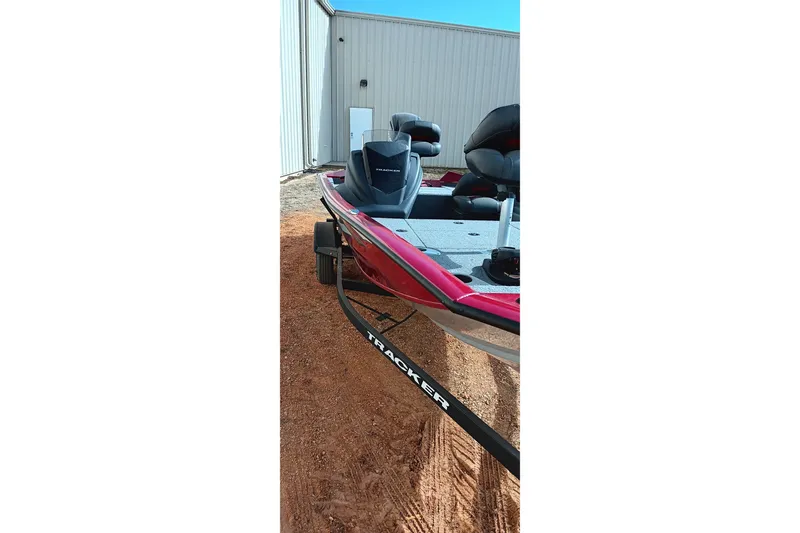 Slide: The Image of 2025 Tracker Pro Team 175 boat on trailer, parked near a building. - 5