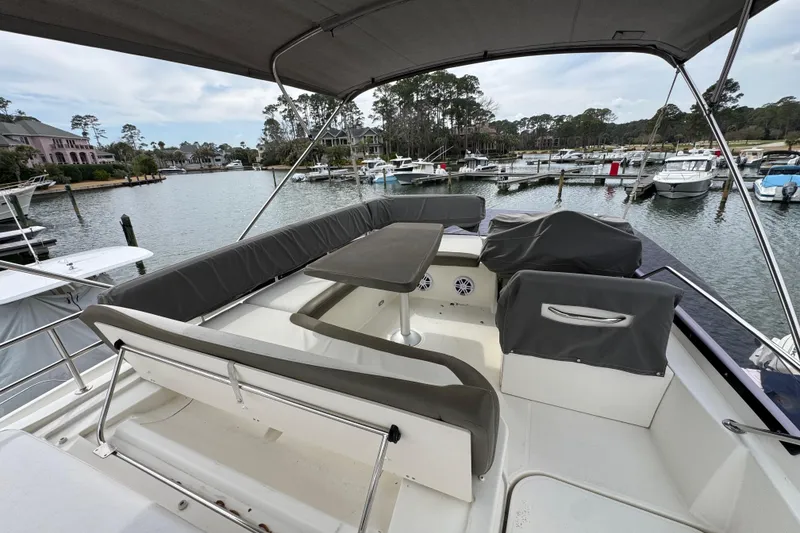 Slide: The Image of 2014 Prestige 400 yacht with spacious seating area in a marina setting. - 10